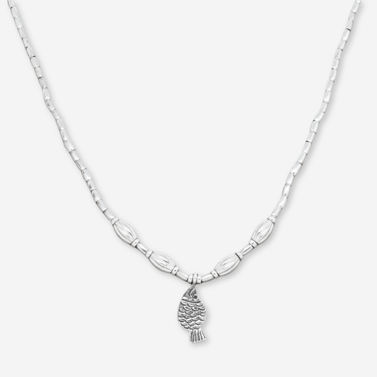 Silver necklace with a fish pendant on a white background