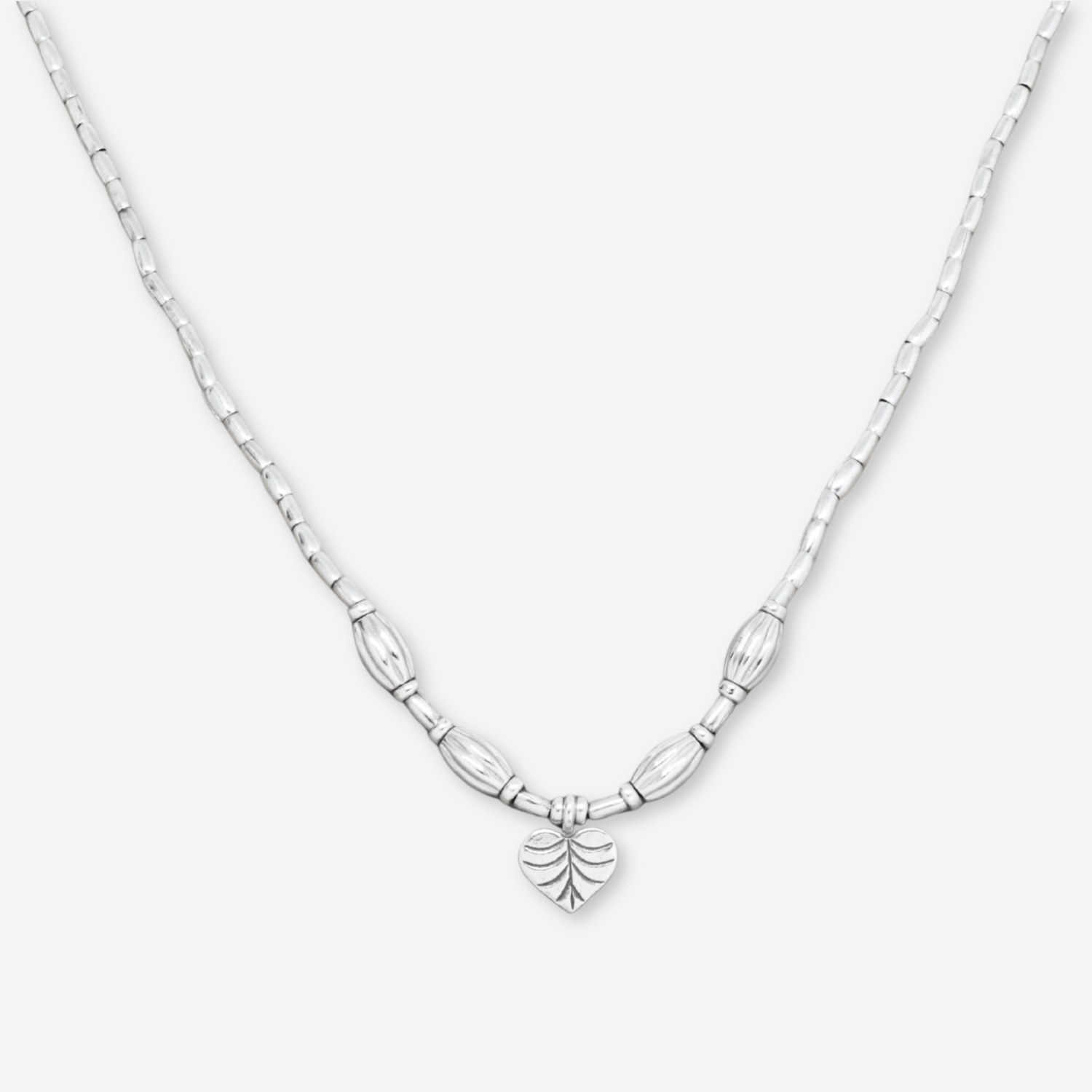 Silver necklace with a leaf-shaped pendant on a white background