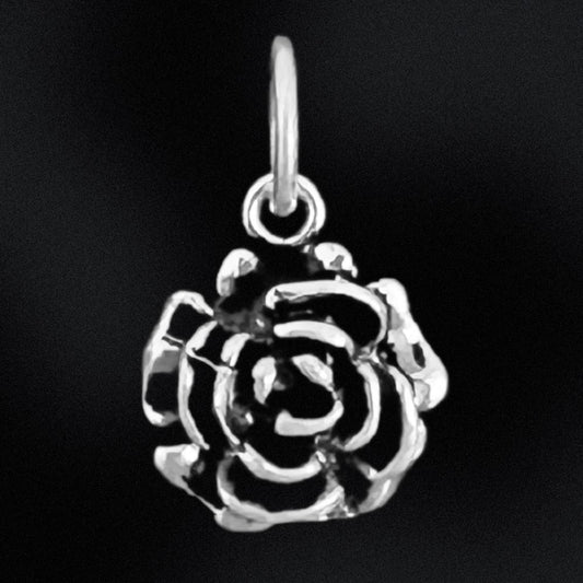 Silver rose-shaped pendant on a black background