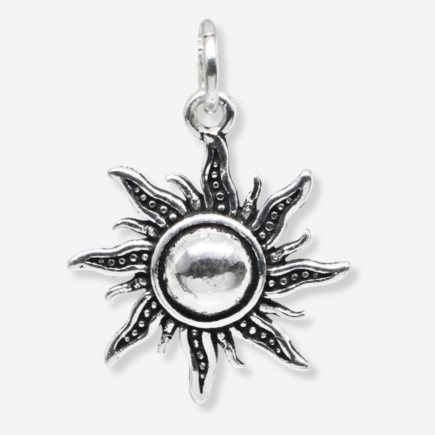 Silver sun-shaped pendant on a white background