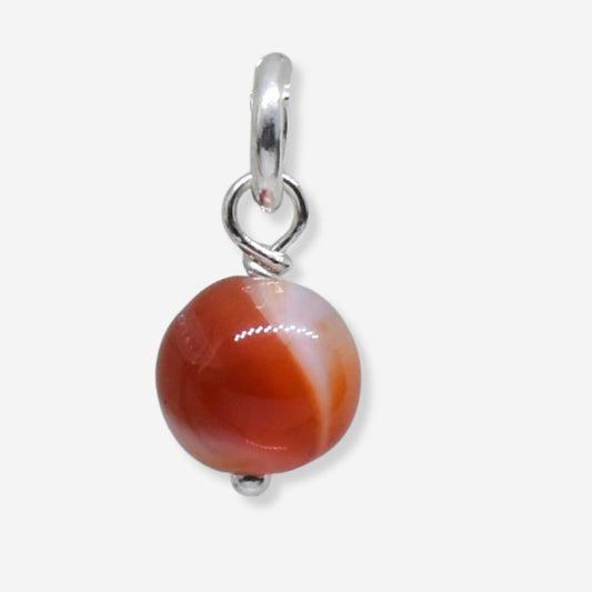 Pendant with a round brown stone and silver chain on a white background