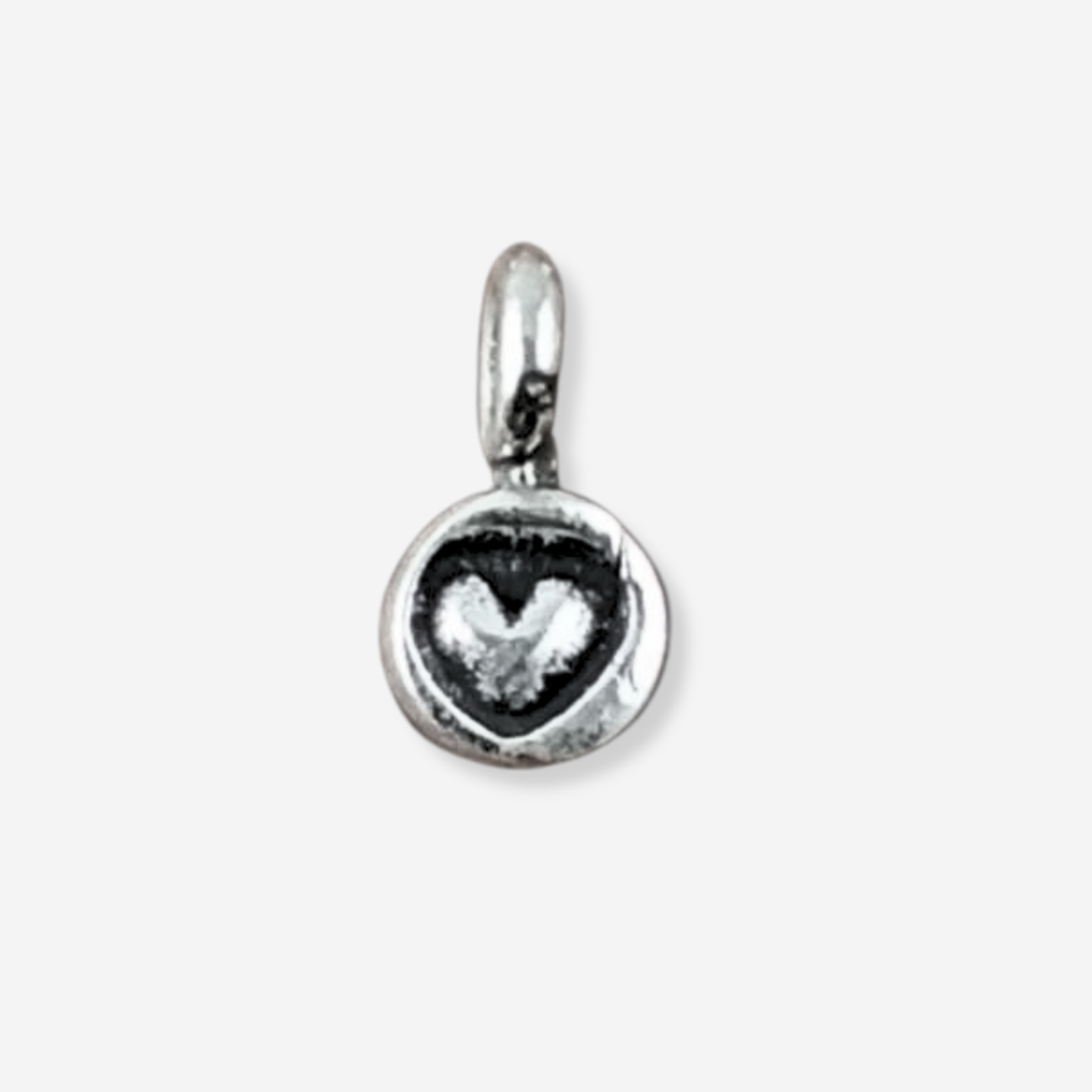 Silver pendant with a heart design on a white background