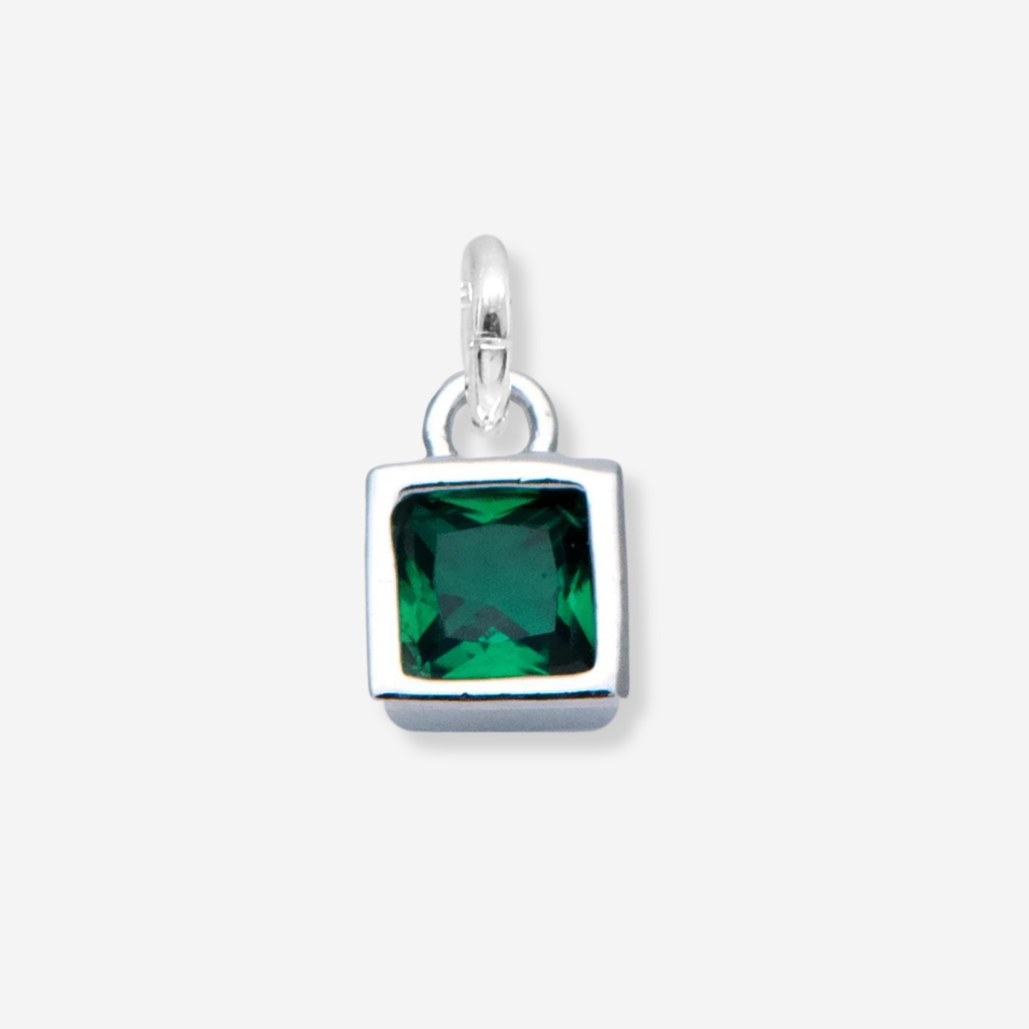 Silver pendant with a green gemstone on a white background