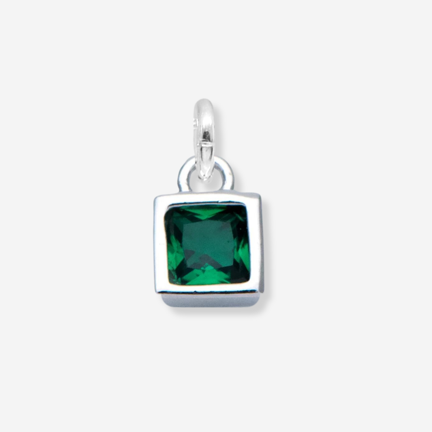 Silver pendant with a green gemstone on a white background