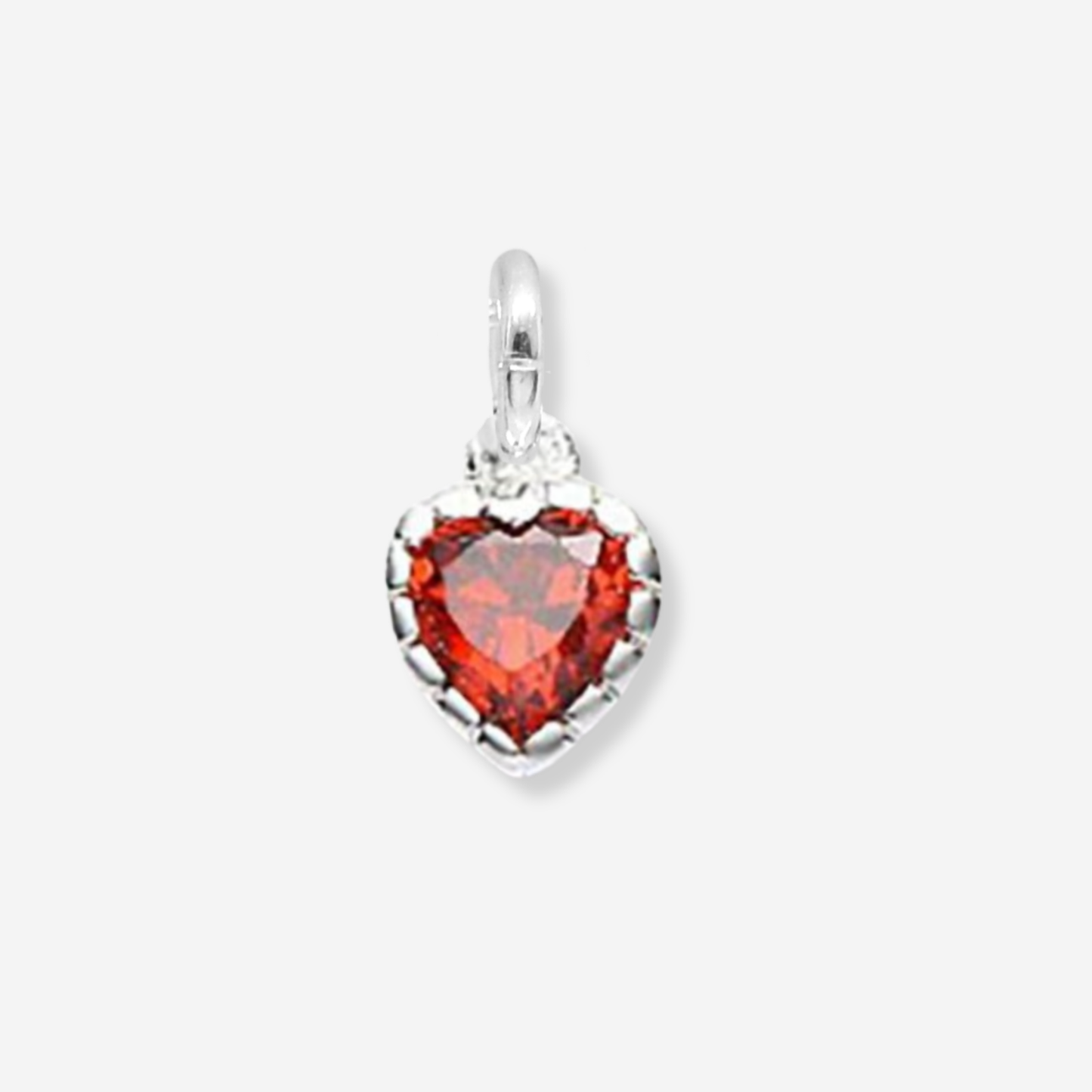 Heart-shaped pendant with red gemstone and silver frame on a white background