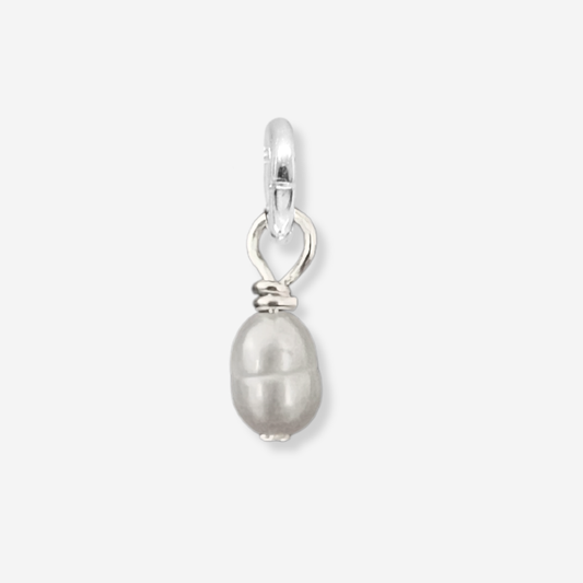 Silver pendant with a pearl on a light gray background