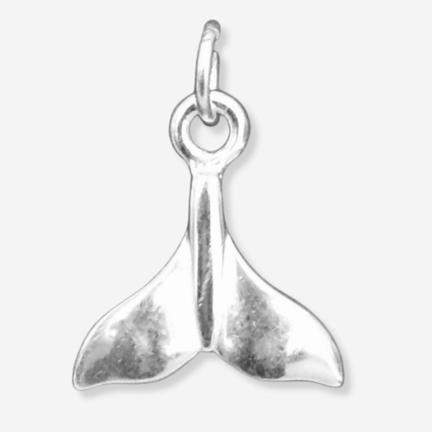 Silver whale tail charm on a white background