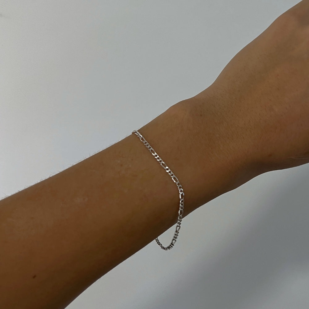 The perfect addition to your everyday wardrobe. This bracelet is perfect for both men and women who want to elevate their style. Whether worn alone or paired with other accessories, this bracelet is sure to become your new go-to statement piece. Its intricate design features interlocking links in a distinct pattern, giving it a bold and eye-catching appearance that is sure to be a staple. But wait, there's more! This Bracelet has matching Necklace.
