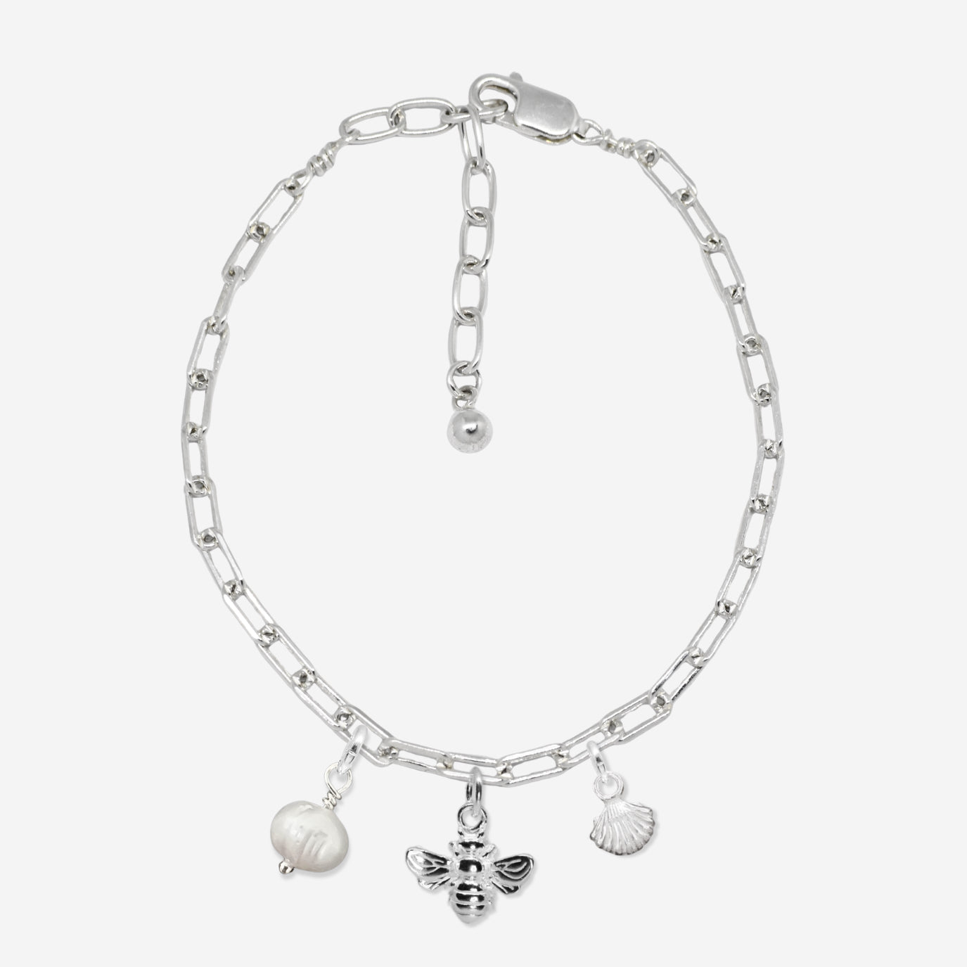 Silver chain bracelet with three charms on a white background