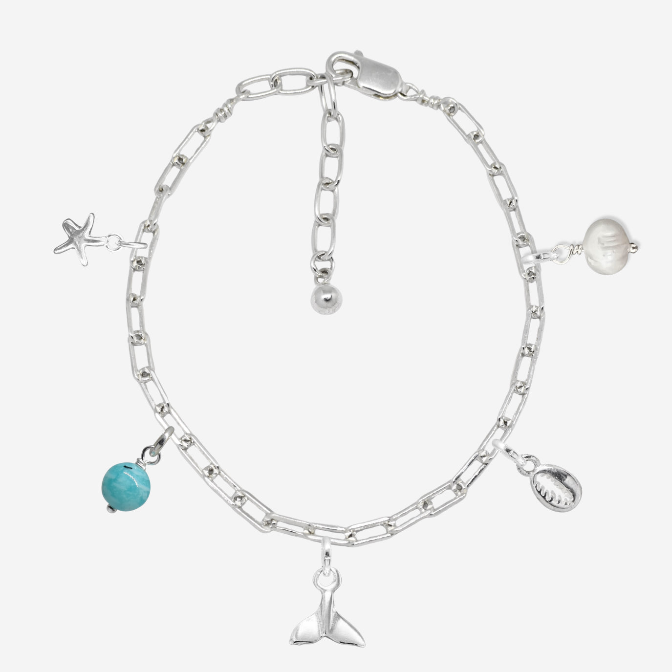 Silver chain bracelet with various charms on a white background