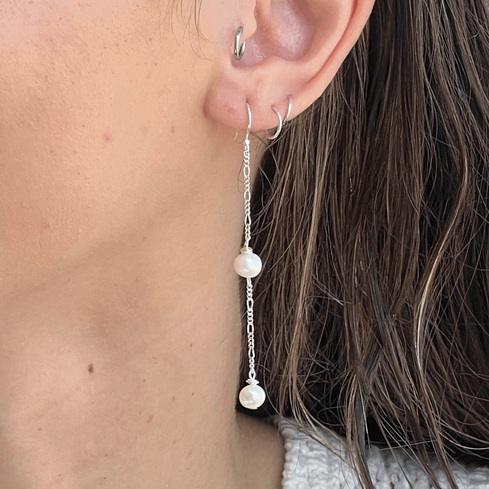 Be the showstopper with these stunning silver Figaro chain earrings! Elegantly featuring a double pearl dangle, these earrings are sure to add some chic sass to any look. Perfect for adding a bit of glam to an outfit, you'll be channeling your inner goddess in no time.