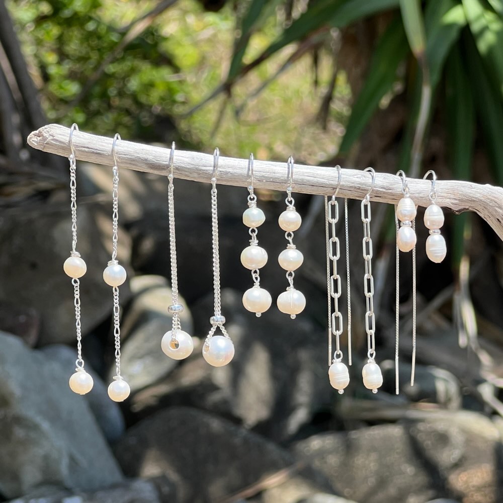 This exquisite Triple Freshwater Pearl Stack Earrings features three freshwater pearls delicately stacked and set in sterling silver. Perfect for adding a touch of elegance to any outfit. These earrings are too good to pass up!