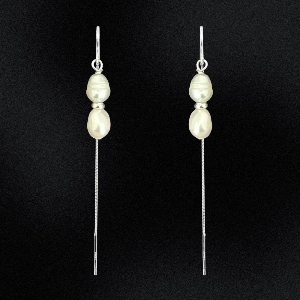 Add some drama and edge to your everyday look with these freshwater double pearl threader earrings! Handcrafted with two freshwater pearls and sterling silver, these earrings will make any outfit double-take fabulous. Perfect for any occasion, add a little pearl-fection to your wardrobe!
