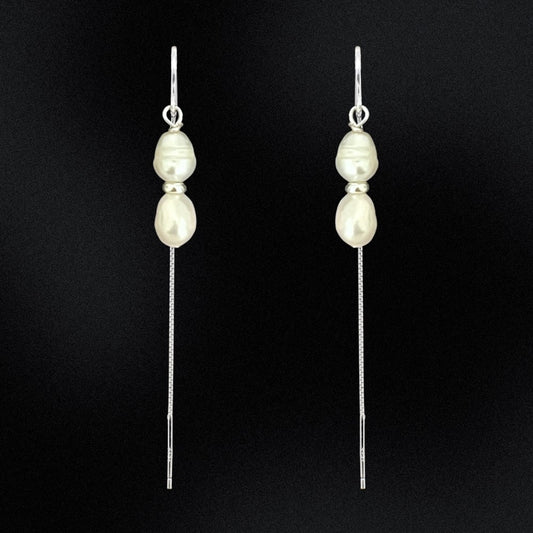 Add some drama and edge to your everyday look with these freshwater double pearl threader earrings! Handcrafted with two freshwater pearls and sterling silver, these earrings will make any outfit double-take fabulous. Perfect for any occasion, add a little pearl-fection to your wardrobe!