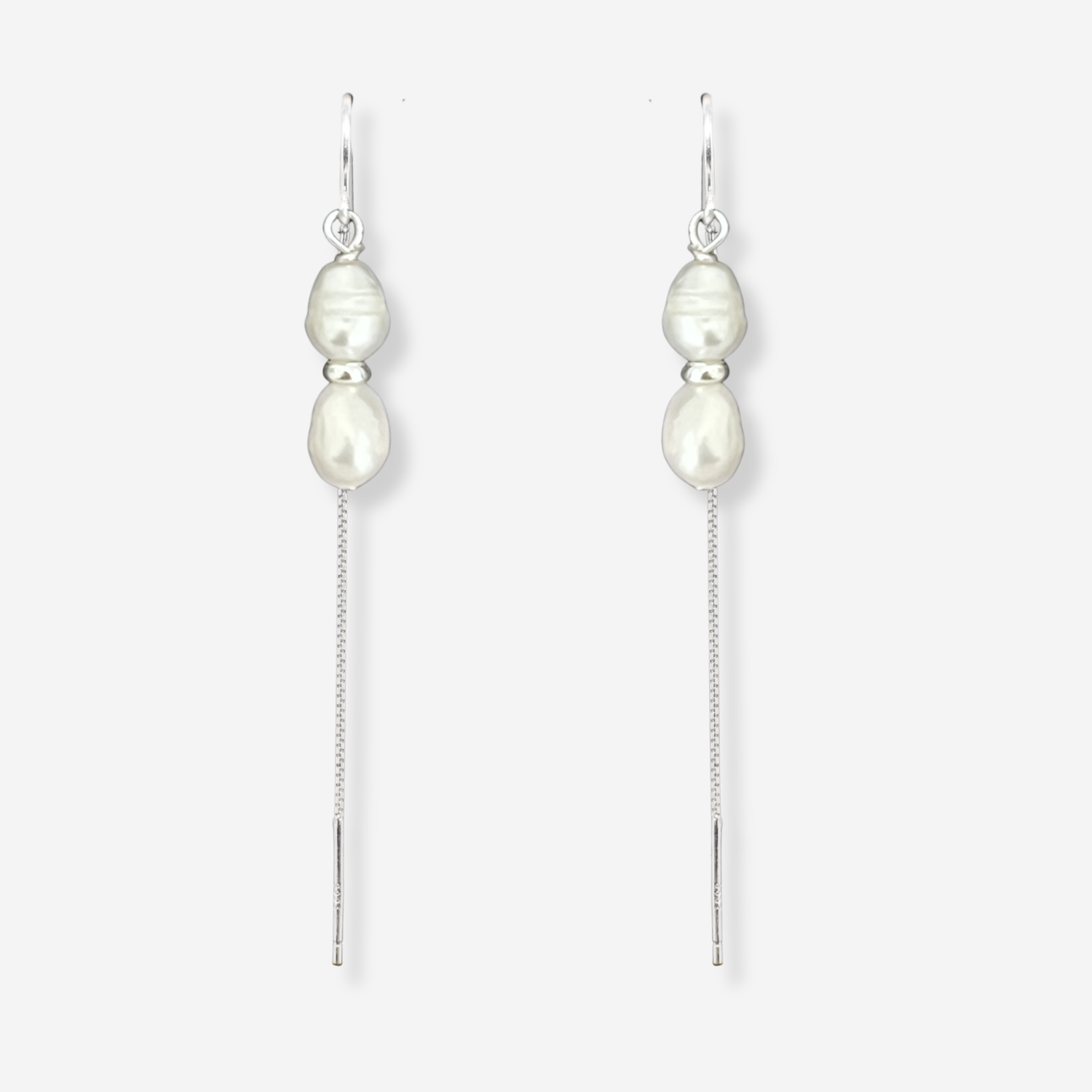 Pearl drop earrings on a white background