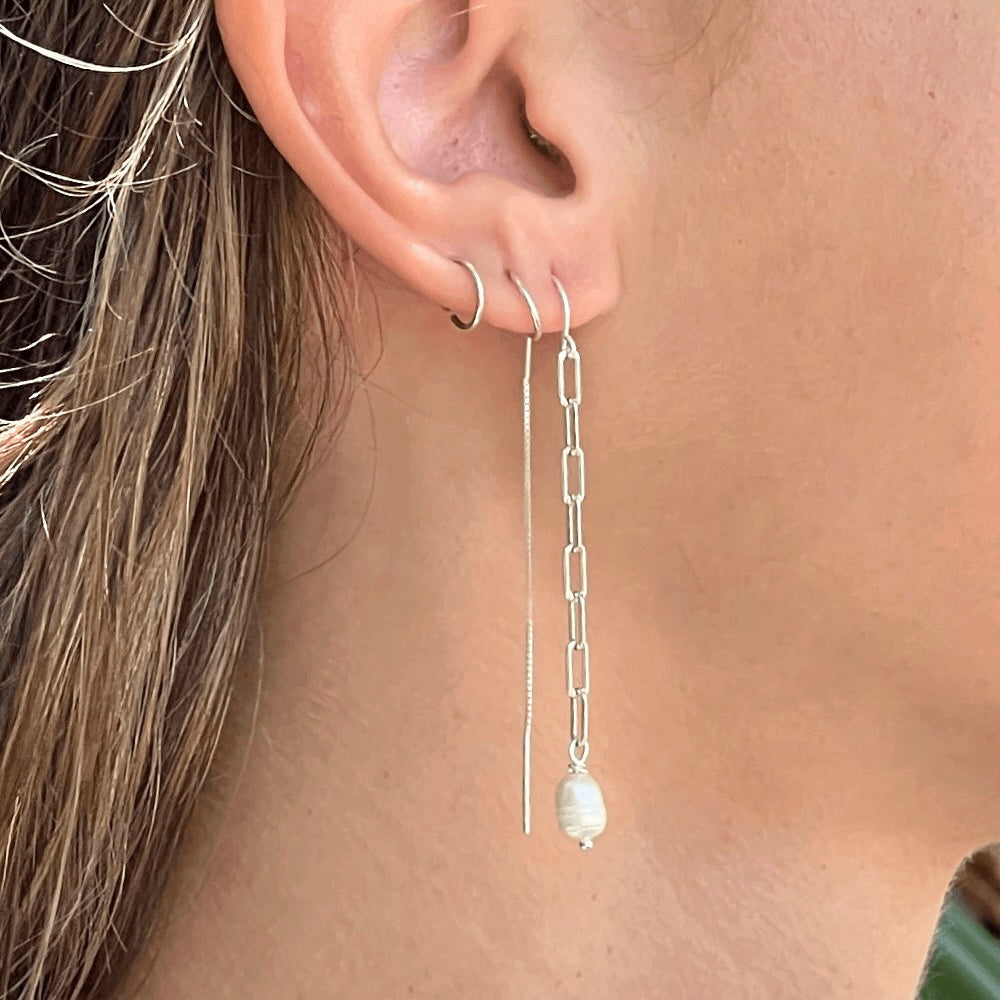 Add a little extra something to any outfit with these fun Paperclip Chain & Pearl Threader Earrings! The unique combination of materials helps create statement pieces that'll have everyone doing double takes. Perfect for any occasion and guaranteed to give your look an edgy twist. Check them out and unlock your potential fashionista status! Pearl-fection.