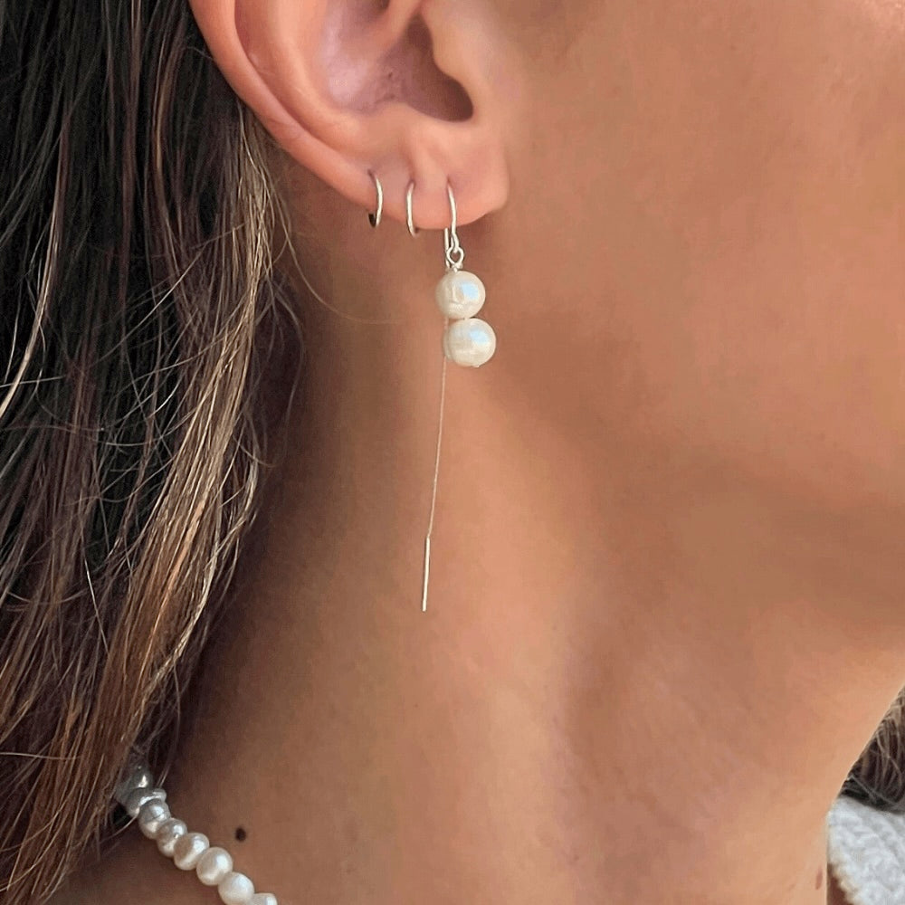 These Double Pearl Stack Threader Earrings are a stunning addition to any jewellery collection! Handcrafted in Australia with sterling silver, these earrings are perfect for any occasion. Exquisite, sophisticated, and stylish, these earrings will add a luxurious sparkle to any ensemble!
