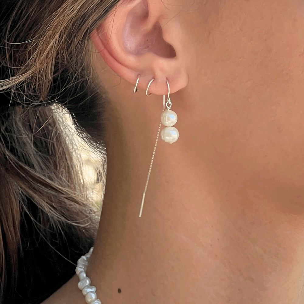 These Double Pearl Stack Threader Earrings are a stunning addition to any jewellery collection! Handcrafted in Australia with sterling silver, these earrings are perfect for any occasion. Exquisite, sophisticated, and stylish, these earrings will add a luxurious sparkle to any ensemble!