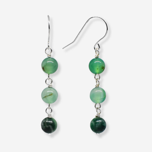 Green beaded earrings on a white background