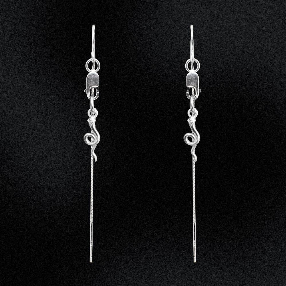 Pair of silver threader earrings on a black background