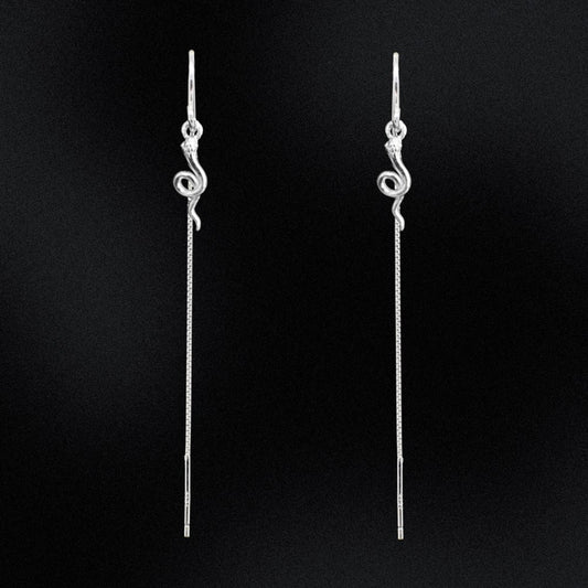Pair of silver threader earrings on a black background